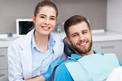 man smiling with dentist getting crowns and bridges, Rockaway, NJ & East Hanover, NJ